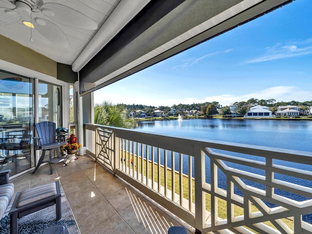 balcony with a water view and ceiling fan