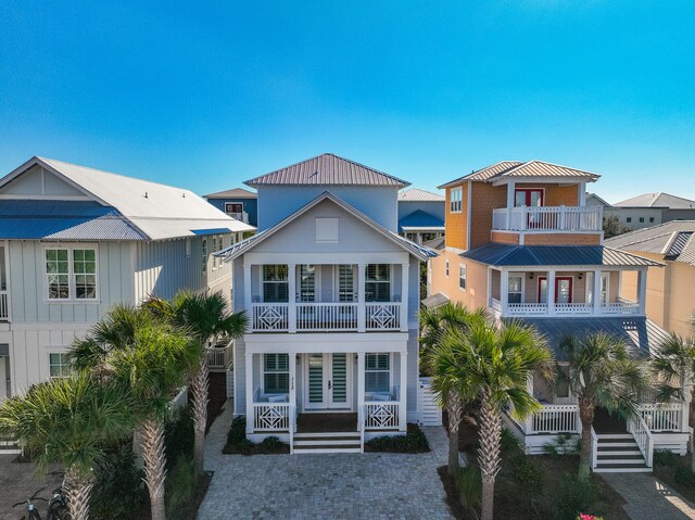 view of front of house featuring french doors and a balcony