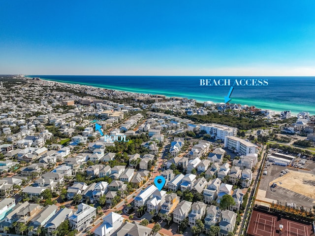 drone / aerial view with a beach view and a water view