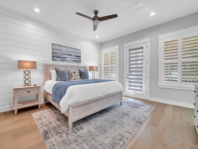 bedroom with access to exterior, light hardwood / wood-style flooring, and ceiling fan