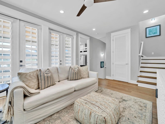 living room featuring ceiling fan, french doors, and light wood-type flooring