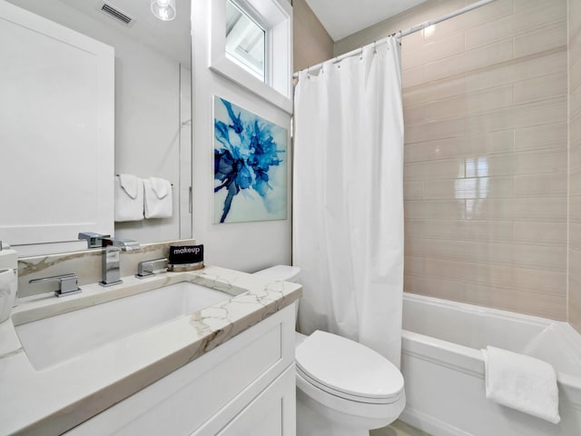 full bathroom featuring shower / bath combination with curtain, vanity, and toilet