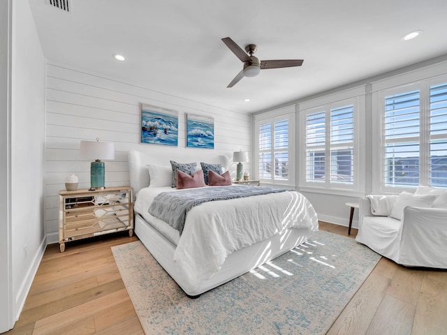 bedroom featuring multiple windows, ceiling fan, and light wood-type flooring