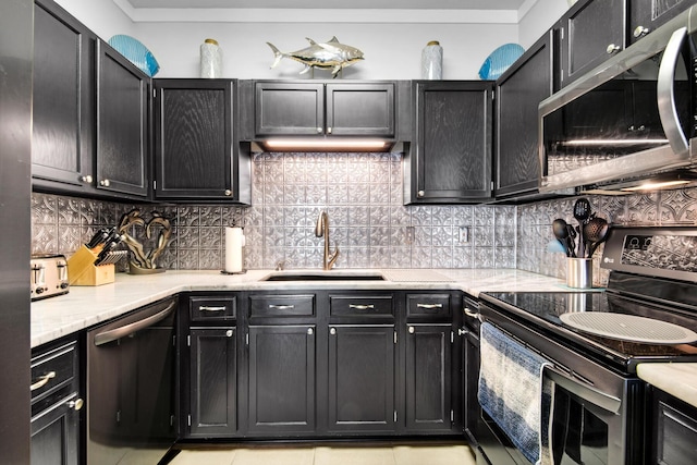 kitchen featuring tasteful backsplash, sink, light tile patterned floors, and appliances with stainless steel finishes