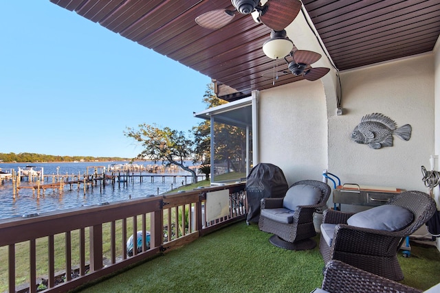 balcony with a water view and grilling area