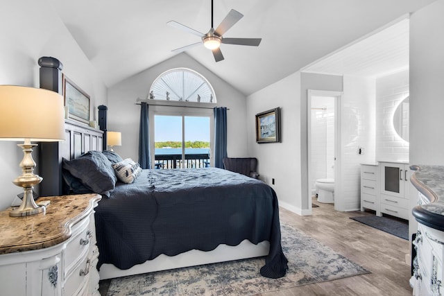 bedroom featuring ceiling fan, ensuite bathroom, light hardwood / wood-style floors, lofted ceiling, and access to outside