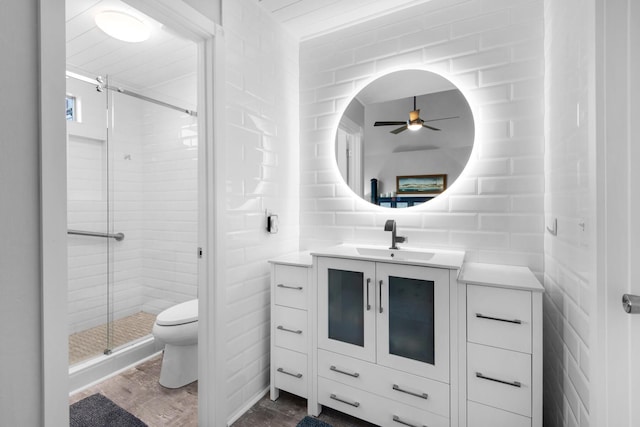 bathroom featuring hardwood / wood-style floors, vanity, ceiling fan, toilet, and an enclosed shower