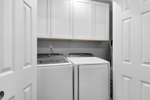 laundry room featuring cabinets and separate washer and dryer