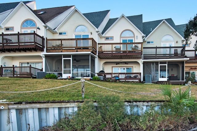 back of house featuring a lawn, ceiling fan, and cooling unit