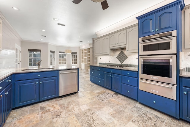 kitchen featuring a warming drawer, visible vents, a sink, appliances with stainless steel finishes, and decorative backsplash