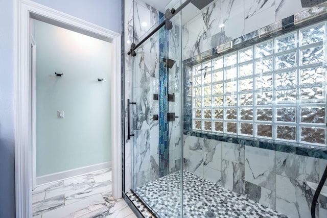 bathroom featuring a marble finish shower, marble finish floor, and baseboards