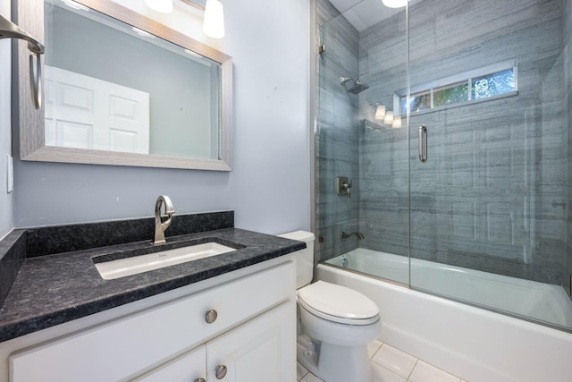 bathroom with tile patterned flooring, combined bath / shower with glass door, toilet, and vanity