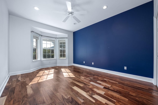 unfurnished room with recessed lighting, a ceiling fan, baseboards, and wood finished floors