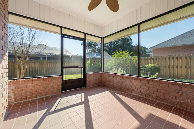 unfurnished sunroom with ceiling fan