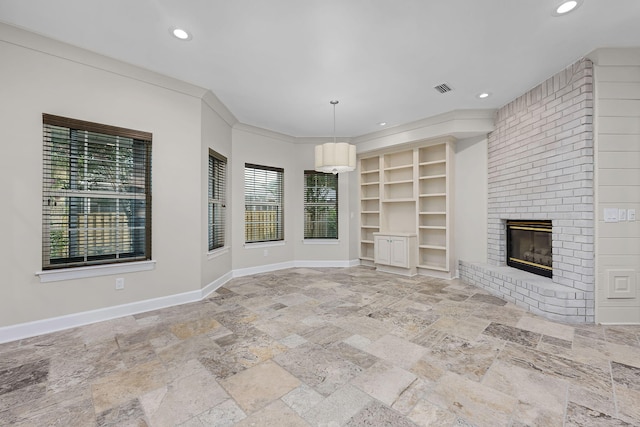 unfurnished living room with baseboards, visible vents, recessed lighting, stone tile flooring, and a brick fireplace