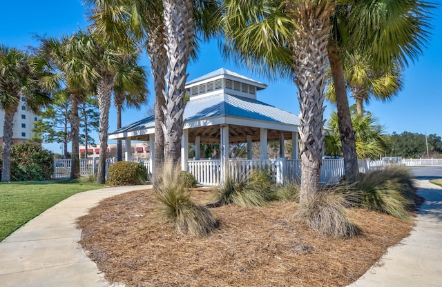 view of front of home featuring a gazebo, metal roof, a front yard, and fence