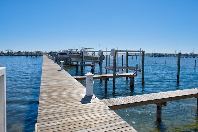 dock area featuring a water view and boat lift