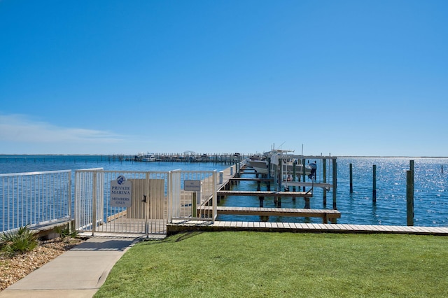 dock area featuring a lawn, a water view, and boat lift