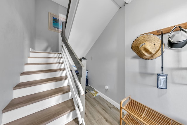 stairs featuring wood-type flooring