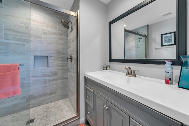 bathroom featuring vanity, an enclosed shower, and hardwood / wood-style flooring