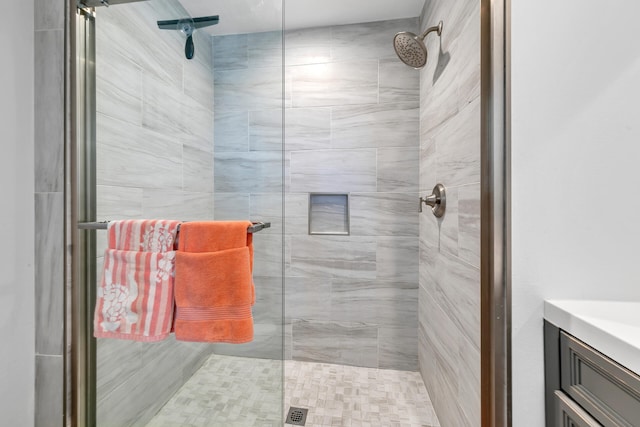 bathroom featuring a shower with shower door