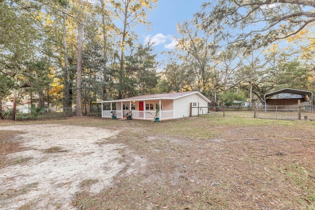 view of front of house featuring a carport and covered porch