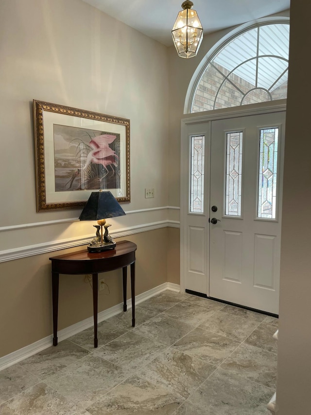 foyer entrance featuring an inviting chandelier