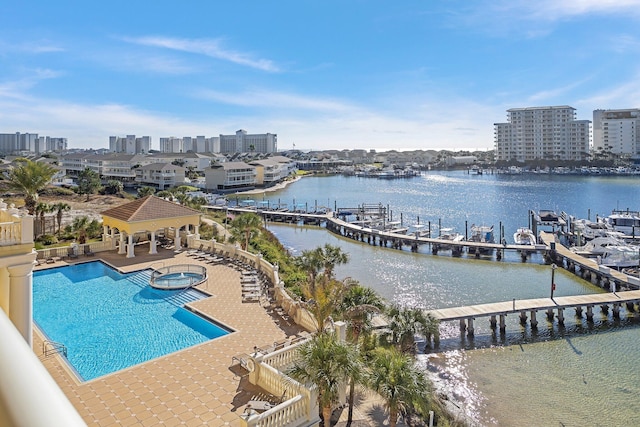 exterior space featuring a community hot tub, a water view, a gazebo, a patio area, and a dock