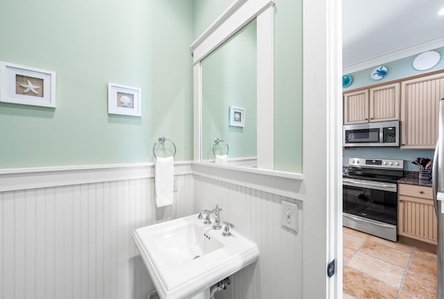 bathroom with crown molding and sink