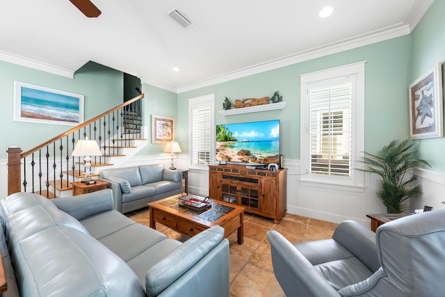 living room with crown molding, plenty of natural light, and ceiling fan