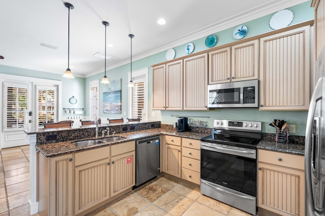 kitchen featuring sink, stainless steel appliances, kitchen peninsula, pendant lighting, and ornamental molding