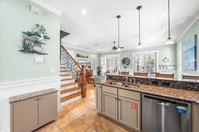 kitchen with dishwasher, dark stone counters, sink, ceiling fan, and decorative light fixtures