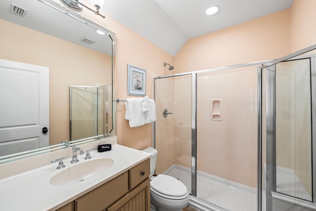 bathroom with toilet, vaulted ceiling, and a shower with shower door