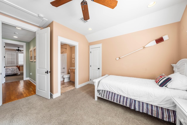 carpeted bedroom featuring connected bathroom, ceiling fan, and lofted ceiling