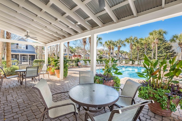 view of patio / terrace with ceiling fan and a community pool