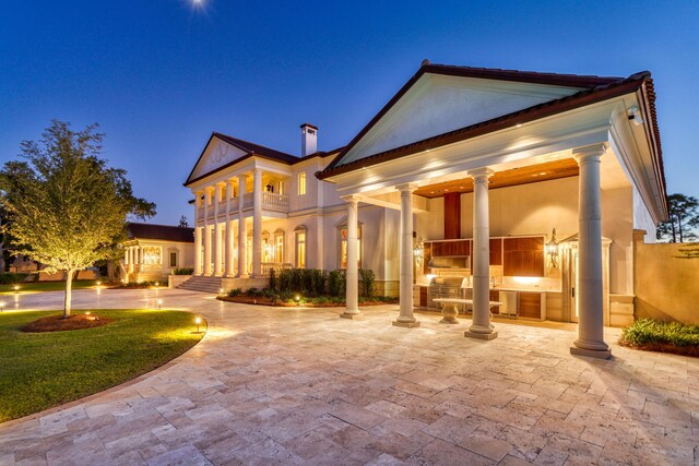 rear view of house featuring an outdoor kitchen