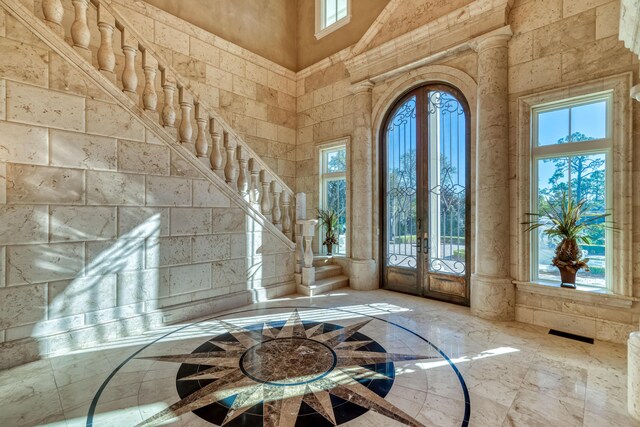 entrance foyer with a towering ceiling and french doors