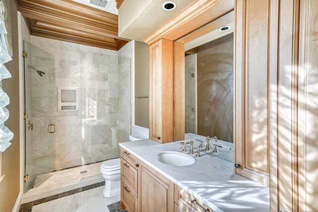 bathroom featuring vanity, toilet, a shower with door, and crown molding