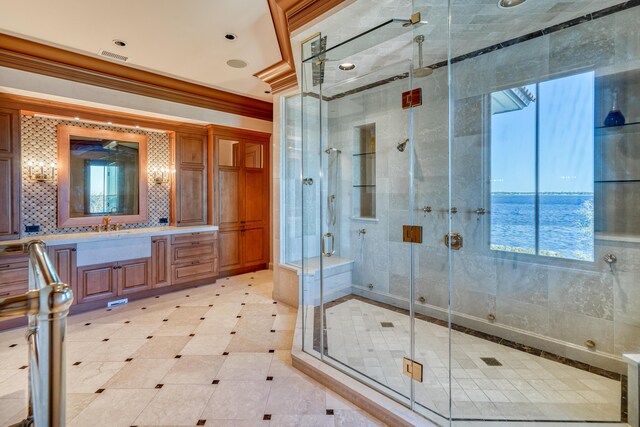 bathroom featuring vanity, a water view, an enclosed shower, and ornamental molding