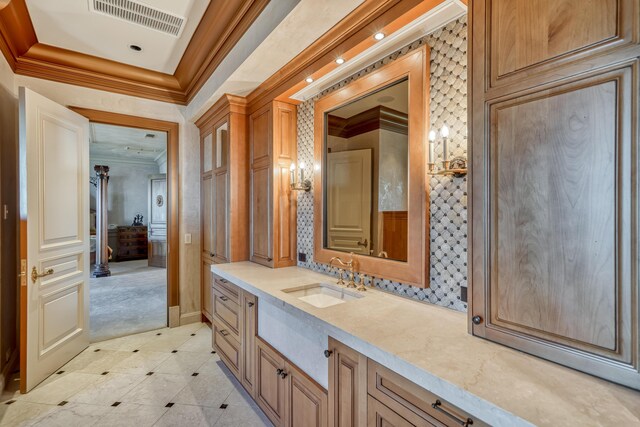 bathroom featuring crown molding and vanity