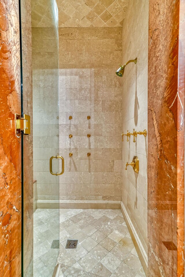 bathroom featuring a shower with door