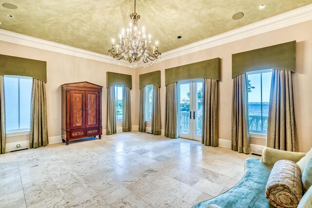 interior space featuring french doors, a water view, ornamental molding, and a notable chandelier