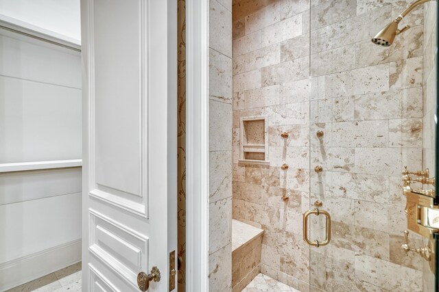 bathroom featuring a shower with shower door