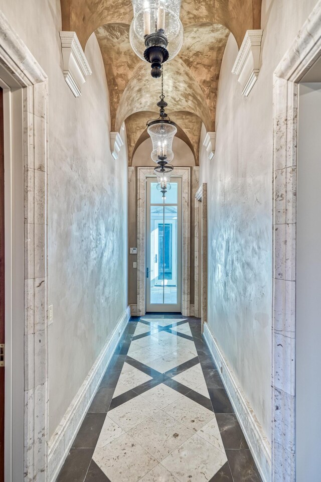 interior space featuring an inviting chandelier and vaulted ceiling