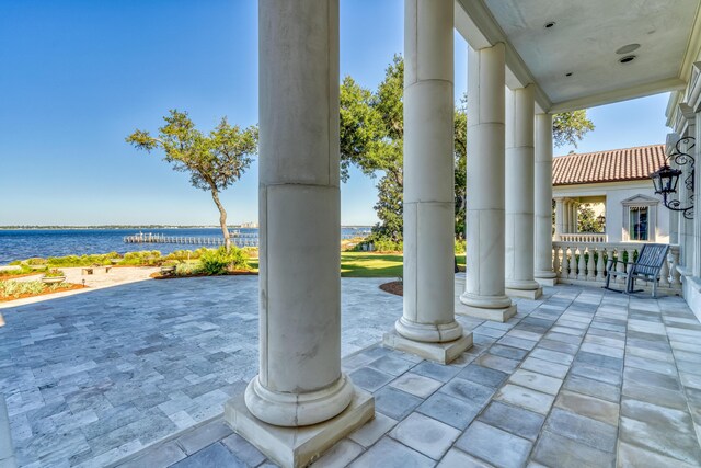 view of patio featuring a porch and a water view