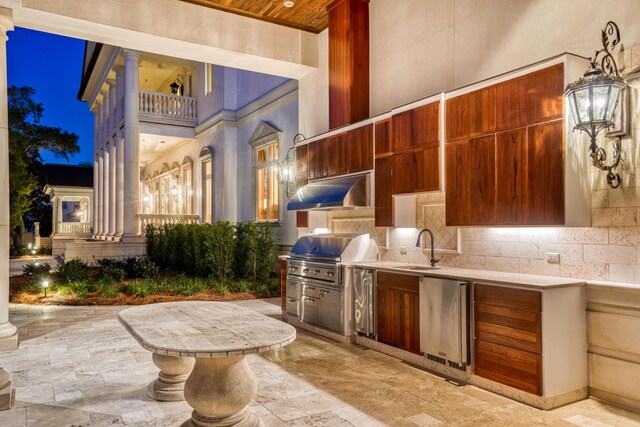 view of patio / terrace with area for grilling, a grill, a balcony, and sink