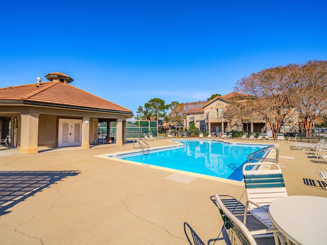 view of pool with a patio area and french doors