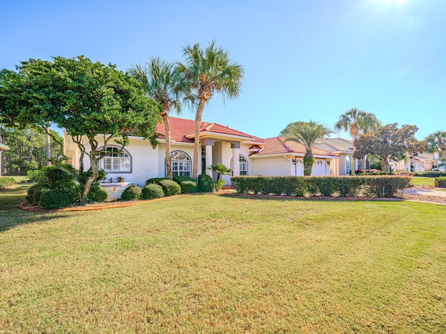 view of front of house with a front yard and a garage