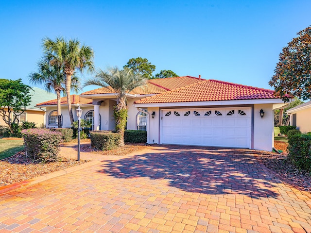 mediterranean / spanish house featuring a garage