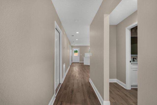 hall featuring dark hardwood / wood-style flooring and sink